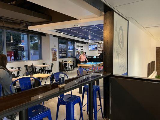 The entrance leading into the restaurant where you can see tables.