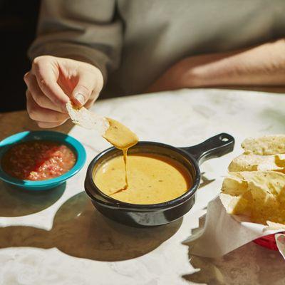 QUESO - Blend of melted cheese, Green Chile & Ranchero Sauces. Add seasoned ground beef, guacamole & pico de gallo.