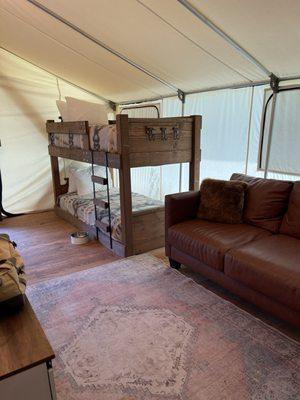 Glamping in one of their tents... Bunk bed off to the side for kids.