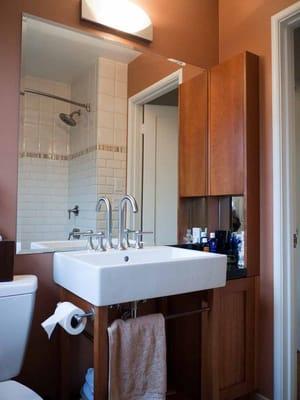 Remodel of small bathroom in El Cerrito CA bungalow with cherry sink vanity and cabinets.