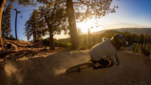 A MTB rider ripping a dirt berm during a Snow Valley Twilight Session evening.