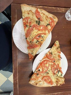 Tomato and Basil Specialty Pizza Slice.