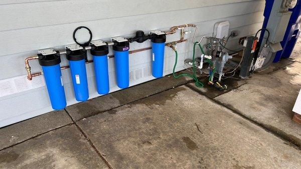 Whole house water filtration system installation.