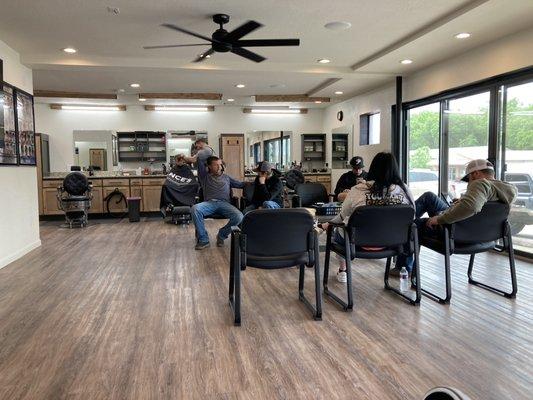 Much bigger waiting area with a 75" big screen TV to watch your favorite sports