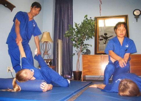 Wilson, assisting other classmates and students in Thai Massage