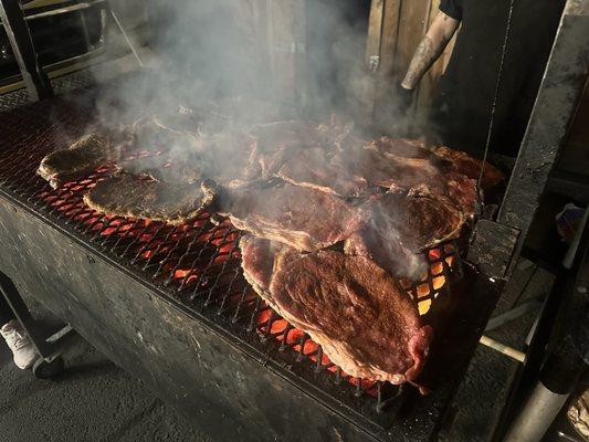 Steak cooking on a charcoal grill