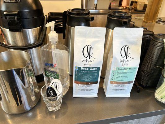 Ordering counter - two bags of coffee for sale, hand sanitizer, and business cards
