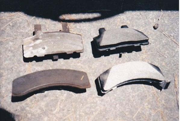 Old brake pads on the left, new pads on the right. See the damage?
