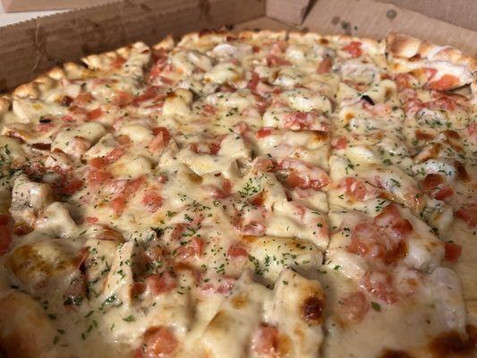 Large Chicken Alfredo pizza with tomatoes added