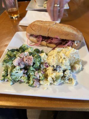 True tip sandwich with potato salad and broccoli salad.