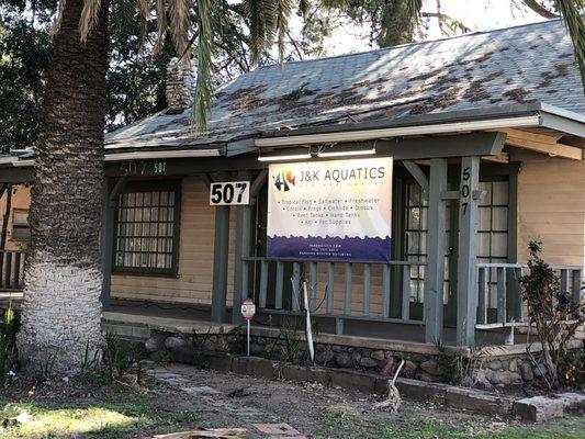 Front. Park in the rear alley next to the Water District building or street.