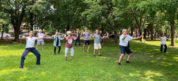 Chicago Tai Chi students following Chris in an outdoor class at Arrigo Park.