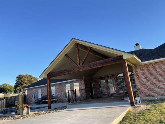 After an installation of an open gable wood porch.