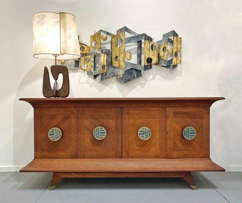 Vintage Lamp and Metal Wall Art hang above a Frank Kyle Credenza with Pepe Mendoza Pulls