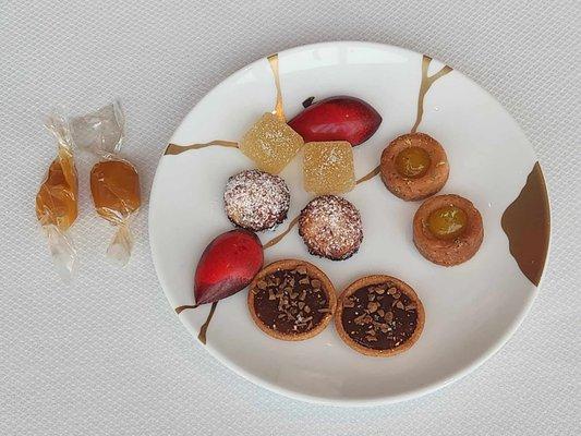 Petit-fours: Toasty coconut macaroons, pineapple yuzu cardamom pate de fruits, caramel chocolate tart, fruit tart, chocolate, and caramels