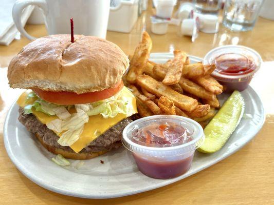 Cheeseburger with coated steak fries and pickle spear