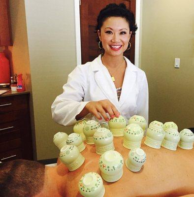 Dr. Teresa Shen, acupuncturist. Performing cupping on a patient.