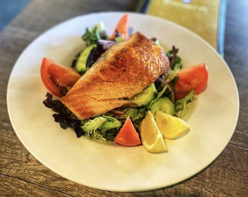 Fresh organic spring mix salad with salmon