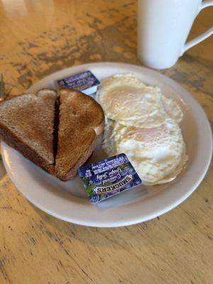 Two eggs with toast and coffee.