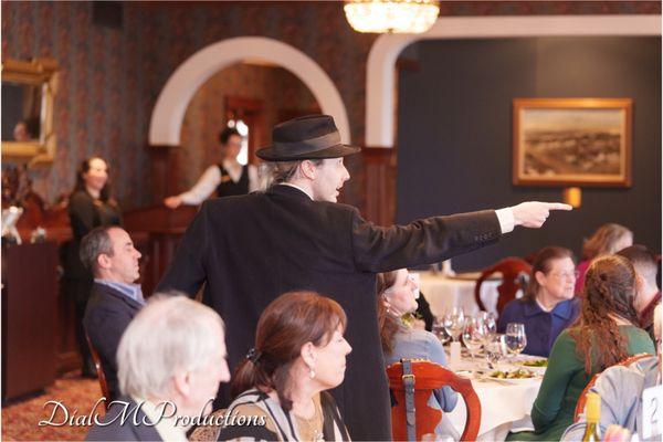 Detective Riley points out a suspect in A Dial M Murder Mystery