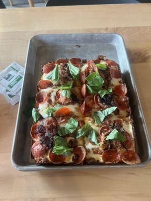 Meat lovers pizza with basil added