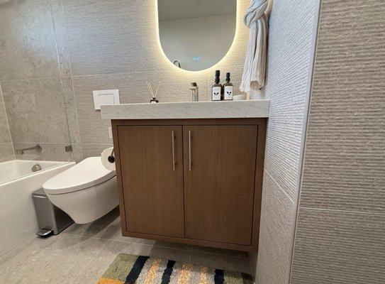 Guest bathroom. Floating vanity with pull out drawer inside cabinet. Stained rift sawn white oak.