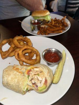 Chicken bacon wrap (snagged a bite first) onion rings sweet fries and a huge juicy burger