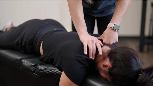 Dr. Molly performing soft tissue therapy for upper back and shoulder pain at Fortitude Performance Chiropractic in Scottsdale.