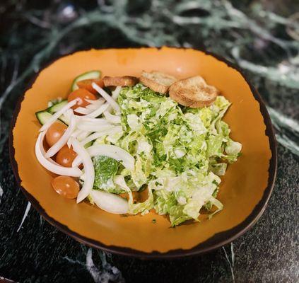 The canal Caesar with added onions, cucumbers, and tomatoes on the side.