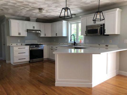 Refaced kitchen with custom molding detail on back and side of island.