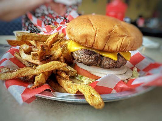 Cheeseburger with French fries. Nice and thick with homemade fries.