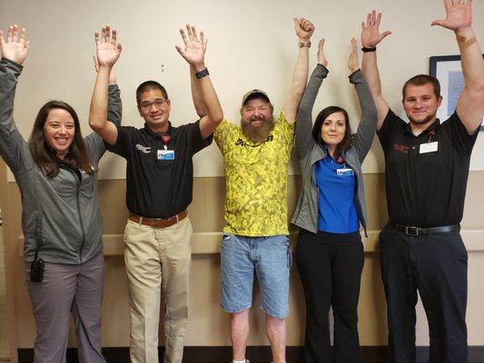 Our patient, Kenneth, celebrating the end of neuro physical therapy with his physical therapists for life!