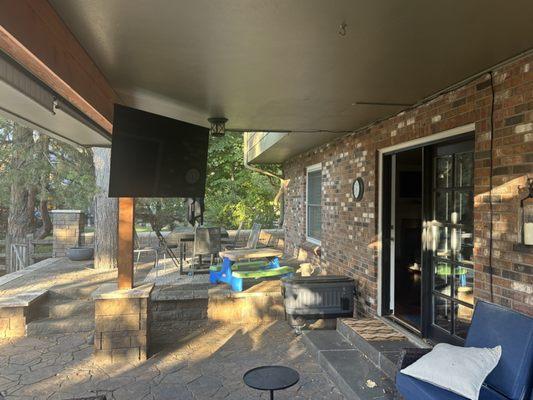 65" TV mounted on a post outside