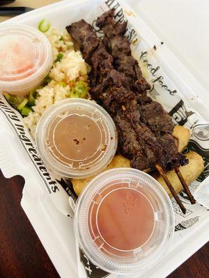 Beef skewers in Hainanese rice, egg rolls with special sauces.