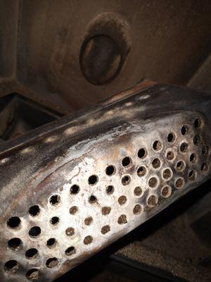 dirty pellet insert pot during a pellet fireplace service