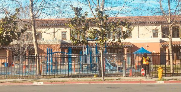 Gated yard with fenced of kindergarten playground.