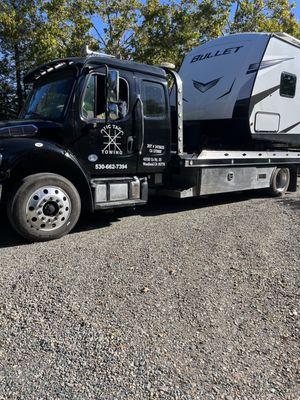 Tow truck with our travel trailer on it