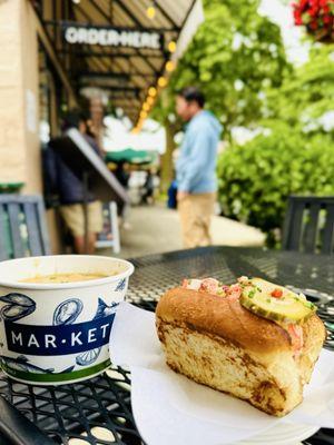 Half cold Lobster Roll and cup of clam chowder. Perfect lunch on a mild summer day.
