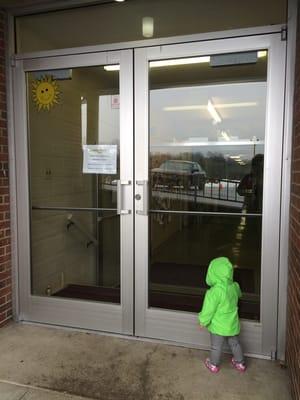 School entrance is in rear of the church building.