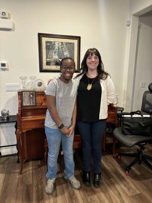 Ms. Abby and her student in front of the piano!