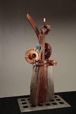 A n impressive small sculpture - "Overachiever" made of found objects, Waethered cherry wood,hand-carved mahogany ,metal form