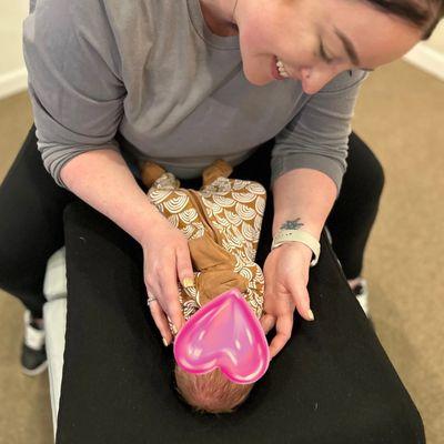 Dr. Aly adjusting a little one