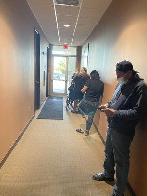 Multiple people waiting in line to get lab work.