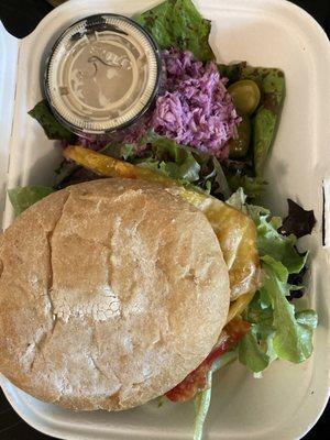 Baharat burger (indian-spiced chickpea+oat burger) with fresh tomatoes and included side of tahini and cole slaw. $11 and so worth it!