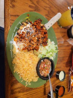 Chori-pollo plate. Flattened chicken with chorizo then topped with cheese dip. Side of rice, beans and a salad.