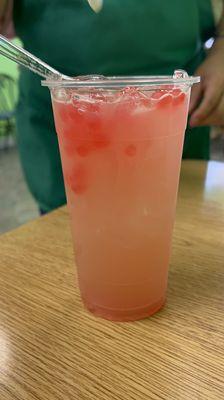 Strawberry green jasmine tea with strawberry popping boba.