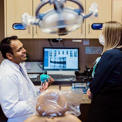 Dr. Thomas talking with employee