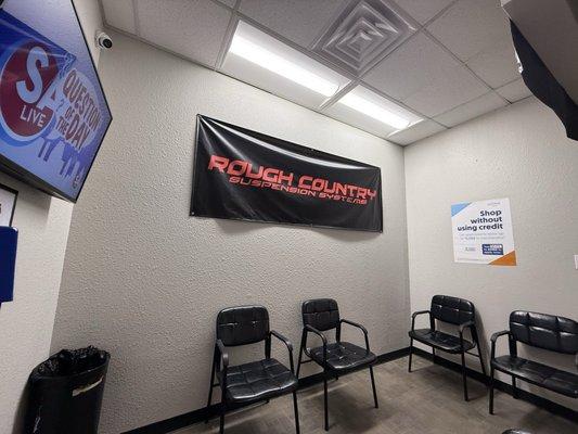 Comfy waiting room with TV, trash and 6 chairs