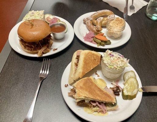 Cubano panini, soft pretzel with cheese dip & house pickles, pulled pork sando