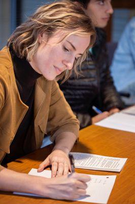 A student writing her college essay during our writing workshop.